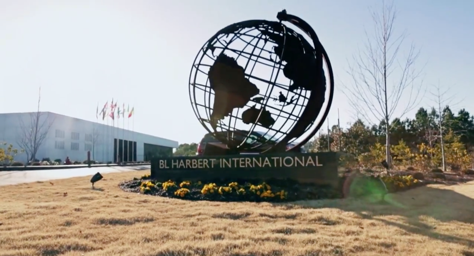 Sign outside BL Harbert International headquarters featuring a large globe